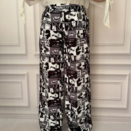 شلوار پارچه‌ای بگ زنانه با طرح گرافیکی چهره زن، نمای جلو در تن مانکن