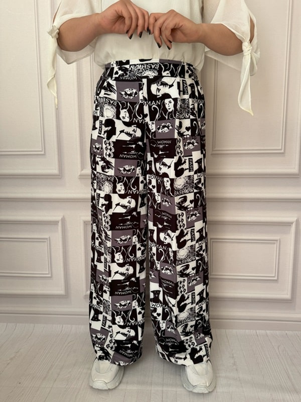 شلوار پارچه‌ای بگ زنانه با طرح گرافیکی چهره زن، نمای جلو در تن مانکن